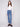 Medium blue jeans featuring a long length and stylish button accents, designed by Charlie B.