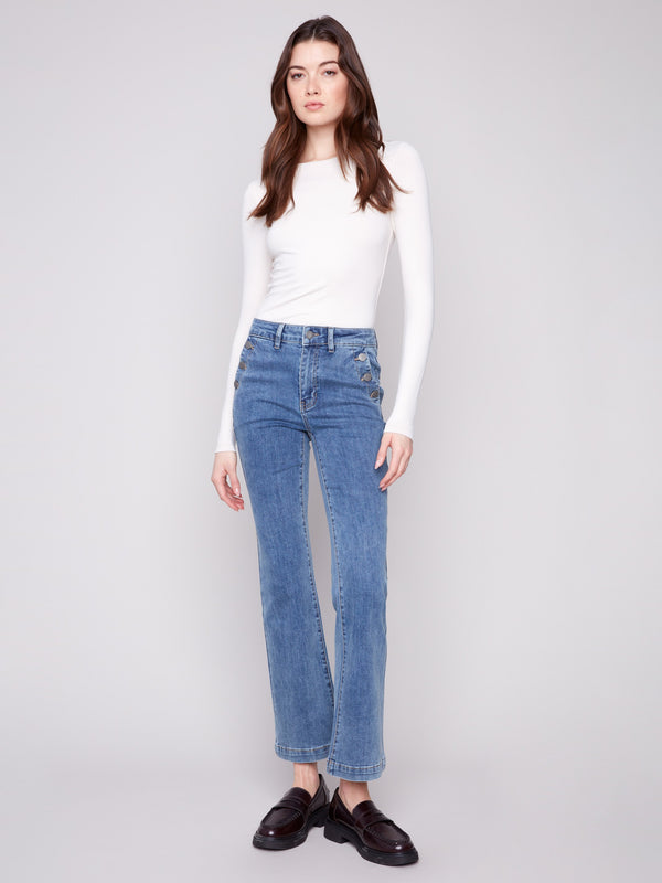 Medium blue jeans featuring a long length and stylish button accents, designed by Charlie B.
