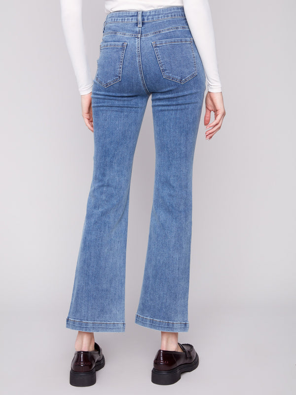 Medium blue jeans showcasing back pockets and a sleek flare leg design by Charlie B.