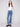 Flare leg stretch denim jeans in medium blue with elegant button details, designed by Charlie B.