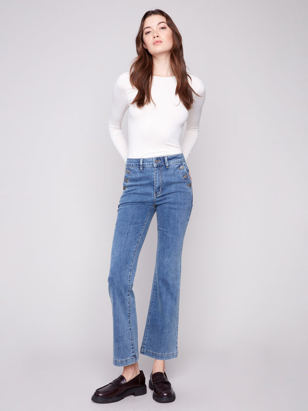 Flare leg stretch denim jeans in medium blue with elegant button details, designed by Charlie B.