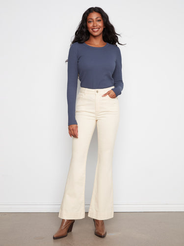 Long length stretch twill pants with a button-zip closure and natural flare leg design by Charlie B.