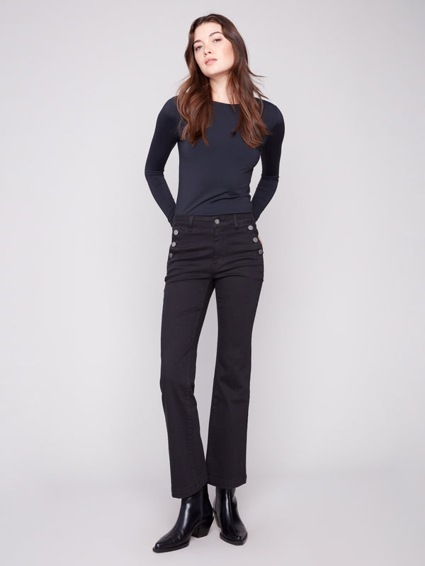 Black stretch twill pants with a long length and button details on the pockets by Charlie B.