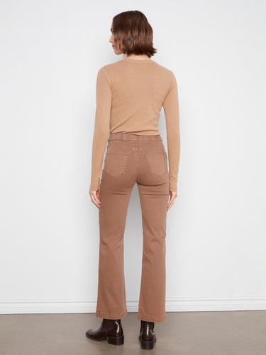 Chic brown flare jeans featuring decorative sailor buttons on the front welts by Charlie B.