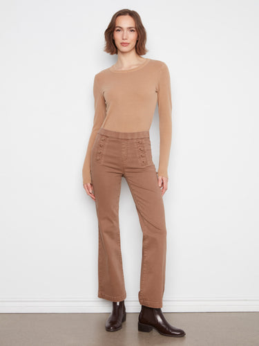 These brown flare jeans offer stretch fabric for ease of movement, adorned with sailor buttons by Charlie B.