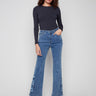 These medium blue jeans feature a stunning flare leg with floral embroidery, perfect for adding flair to any outfit by Charlie B.