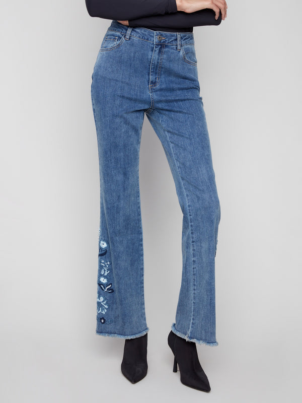 Classic five-pocket design on these medium blue jeans, enhanced with beautiful floral details for added style by Charlie B.