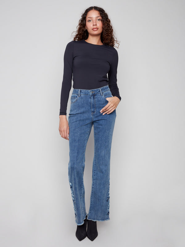 Crafted in stretch denim, these flared jeans offer comfort and elegance with exquisite floral embroidery accents by Charlie B.