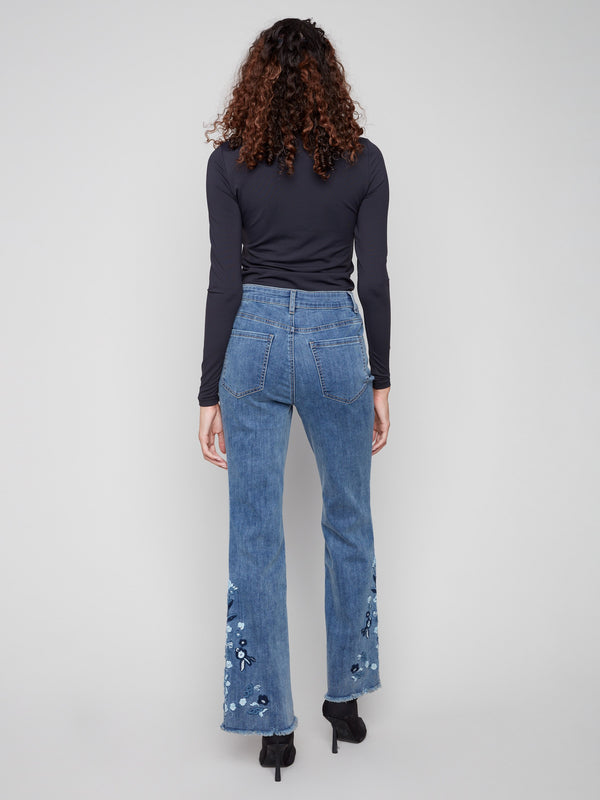 Regular rise flared jeans in medium blue, featuring delicate floral patterns that elevate your casual wardrobe by Charlie B.