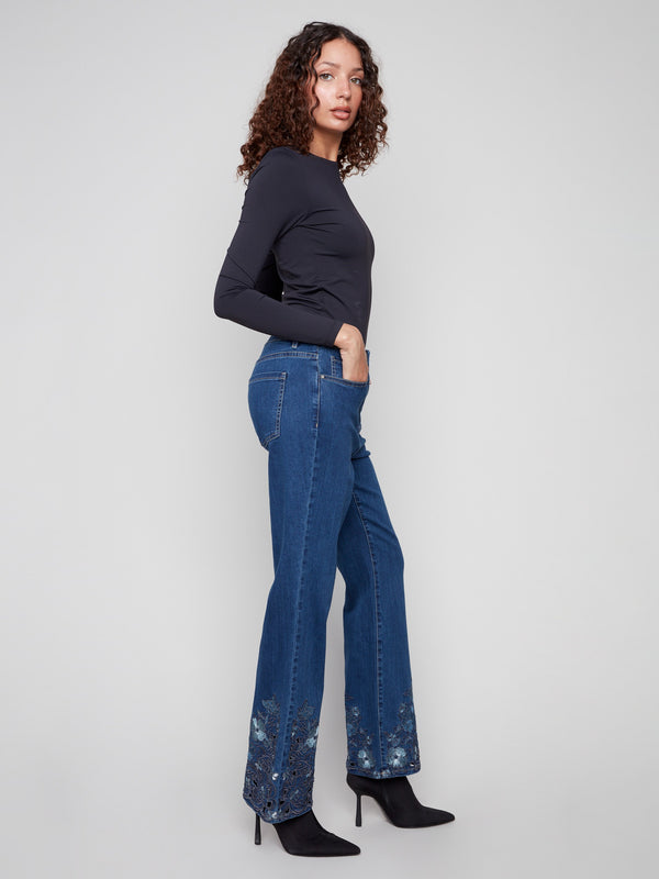 Five-pocket design indigo jeans with elegant floral lace details on the hem, made from stretch denim by Charlie B.