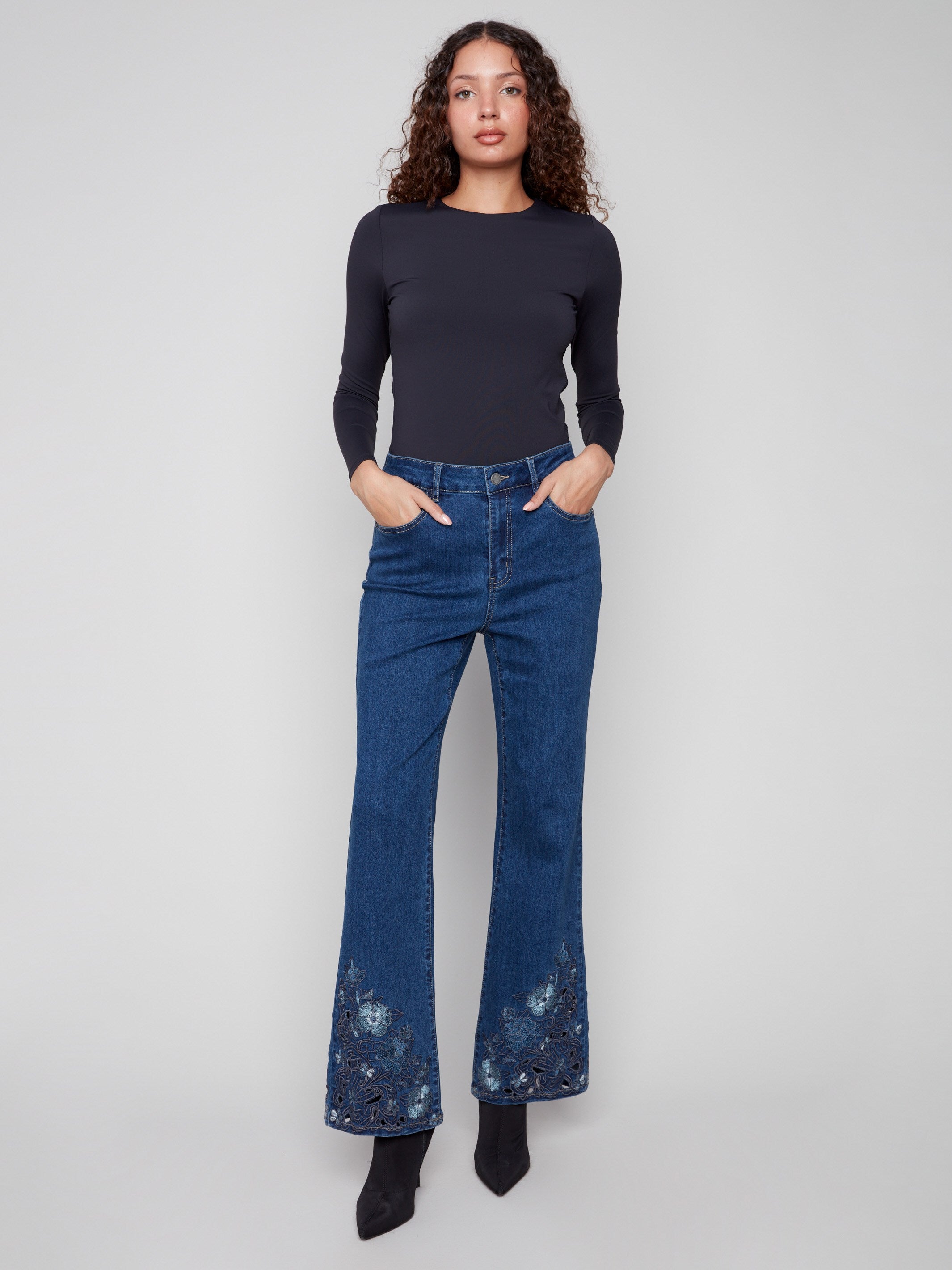 Crafted in stretch denim, these indigo flared jeans showcase exquisite floral embroidery at the hem by Charlie B.