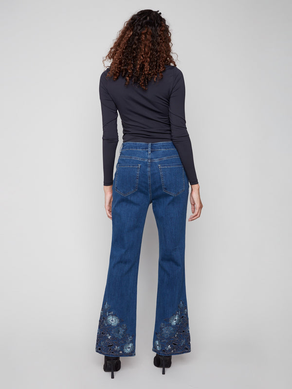 Indigo flared jeans designed with a long length and stylish five-pocket design, featuring lovely lace details by Charlie B.