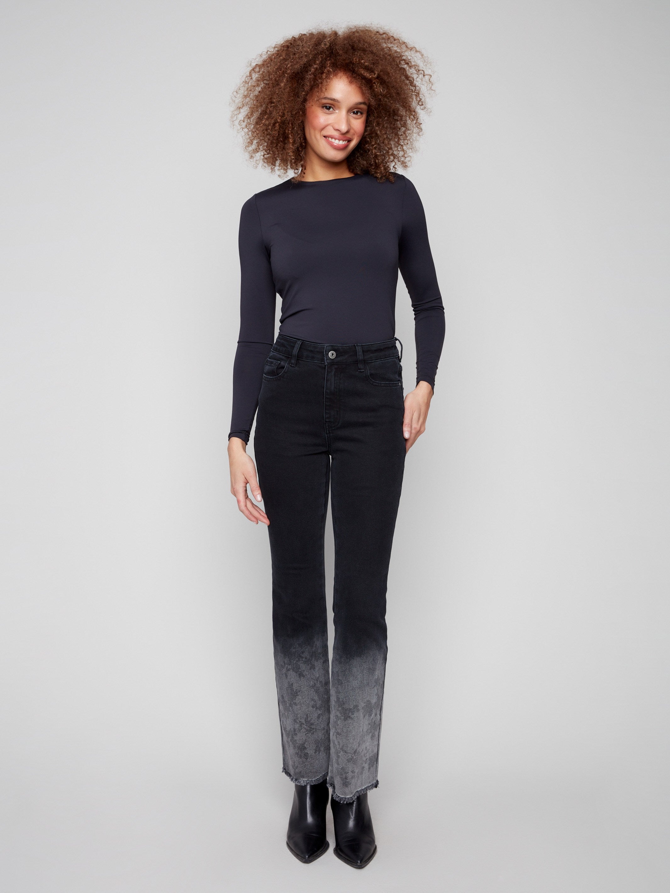 Charcoal flared jeans crafted from stretch denim material, featuring a floral washed hem and button closure by Charlie B.