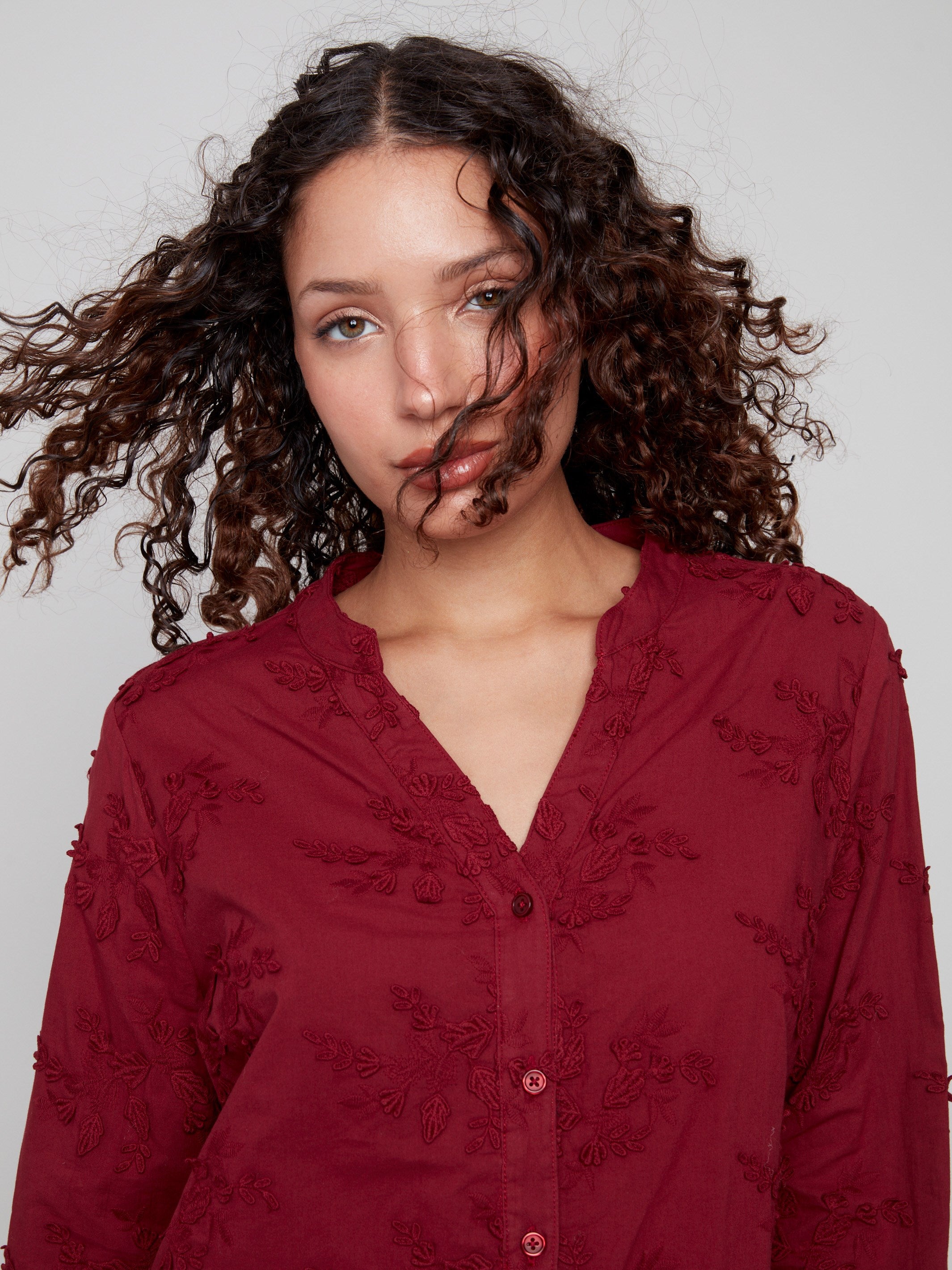 Adjustable button cuffs on this cabernet blouse offer both style and practicality, ideal for versatile wear by Charlie B.