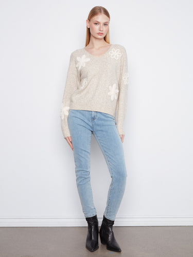 Cozy V-neck sweater in a soft almond shade, adorned with detailed flower appliqués by Charlie B.