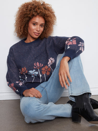Enjoy the comfort of long sleeves on this stylish sweater, adorned with colorful flowers for a touch of elegance. By Charlie B.