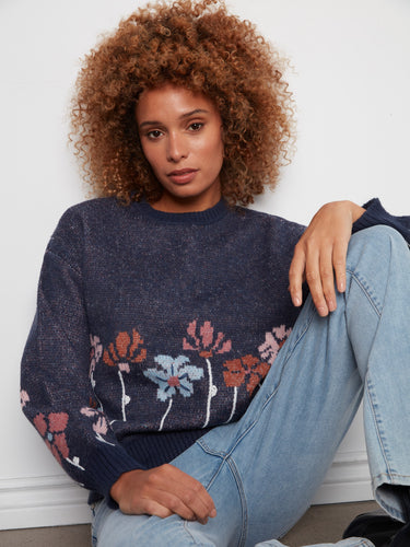Crafted with attention to detail, this sweater's crew neckline and vibrant floral accents offer both style and warmth. By Charlie B.