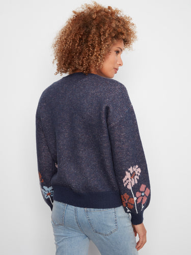 Long sleeves enhance this sweater's cozy appeal while the delicate flower motifs add a playful touch to any outfit. By Charlie B.
