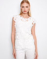 This top features a crew neckline, perfect for a classic and elegant look. The intricate design adds sophistication by Charlie B.