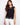 Elegant black top with a crew neckline, featuring intricate crochet design and cap sleeves for a stylish look by Charlie B.