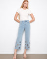 Light blue jeans with a regular rise, showcasing floral cutouts and a cropped length in stretch denim by Charlie B.
