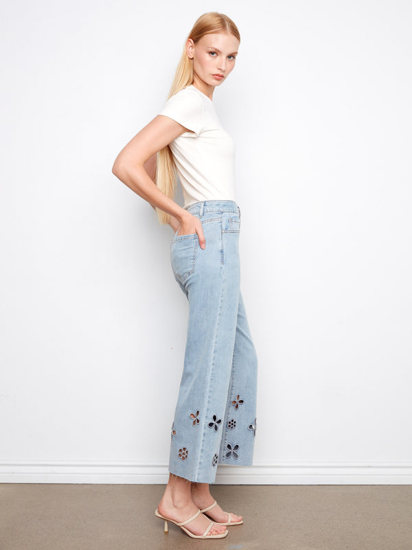 Cropped light blue jeans crafted from stretch denim, adorned with floral cutouts and a five-pocket design by Charlie B.