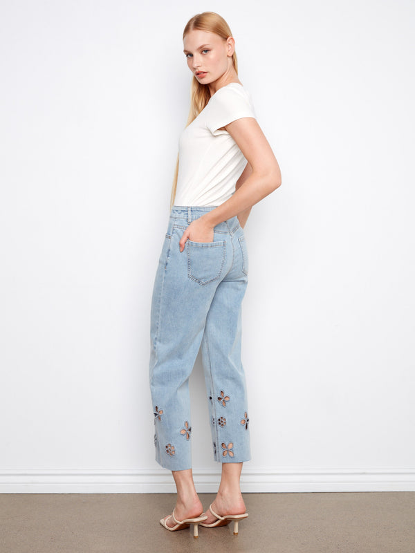 Stylish light blue jeans with a regular rise, wide leg, and detailed floral cutouts for an elegant touch by Charlie B.