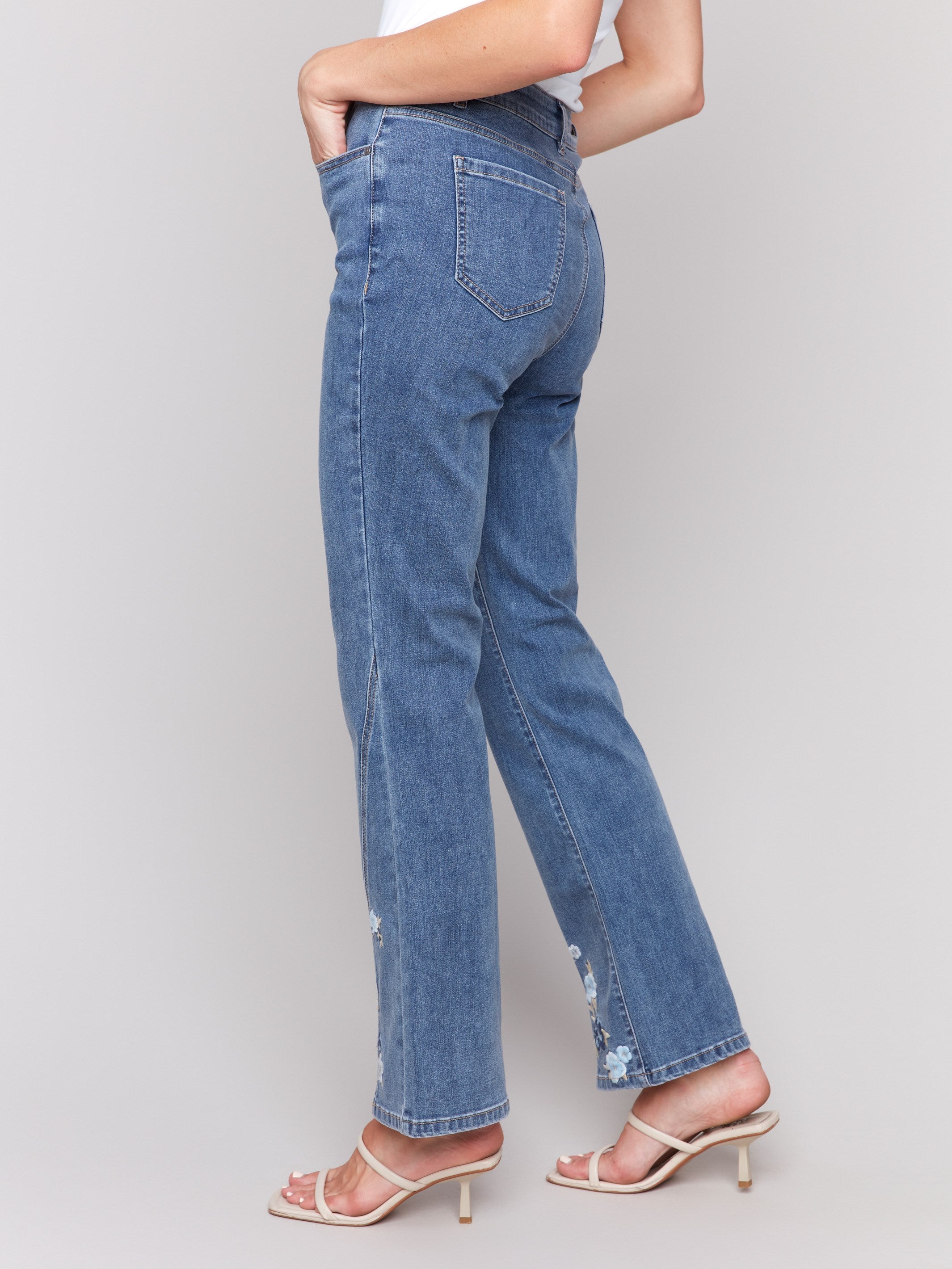 Long length bootcut jeans with intricate floral pattern by Charlie B.