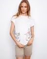 White top with cap sleeves and floral embroidery on cotton fabric, adding a touch of elegance by Charlie B.