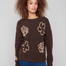Brown sweater with floral embroidery, showcasing drop shoulders and ribbed cuffs for a cozy look by Charlie B.