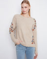 Beige sweater with colorful floral embroidery and long raglan sleeves, offering a cozy fit by Charlie B.