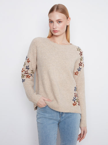 Beige sweater with colorful floral embroidery and long raglan sleeves, offering a cozy fit by Charlie B.