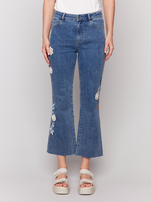 Comfortable stretch denim material in medium blue with floral embroidery by Charlie B.