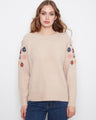 This sweater features a soft knit blend with beautiful floral embroidery along the sleeves, offering a cozy yet stylish look by Charlie B.