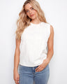 White sleeveless top with intricate floral embroidery, perfect for a summer day. Designed by Charlie B.