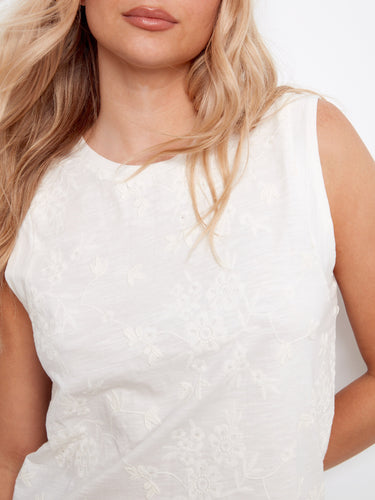Stylish white blouse showcasing beautiful floral embroidery and a comfortable fit. Created by Charlie B.
