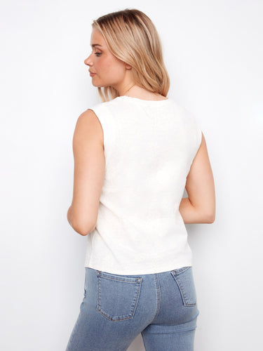 Casual white tank with exquisite floral detailing, adding charm to your wardrobe essentials. By Charlie B.