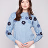 Heather denim sweater with floral embroidery, showcasing a relaxed fit design perfect for casual outings by Charlie B.