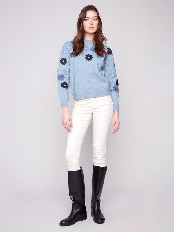 Floral embroidered heather denim sweater featuring drop shoulders for a comfortable and stylish look by Charlie B.