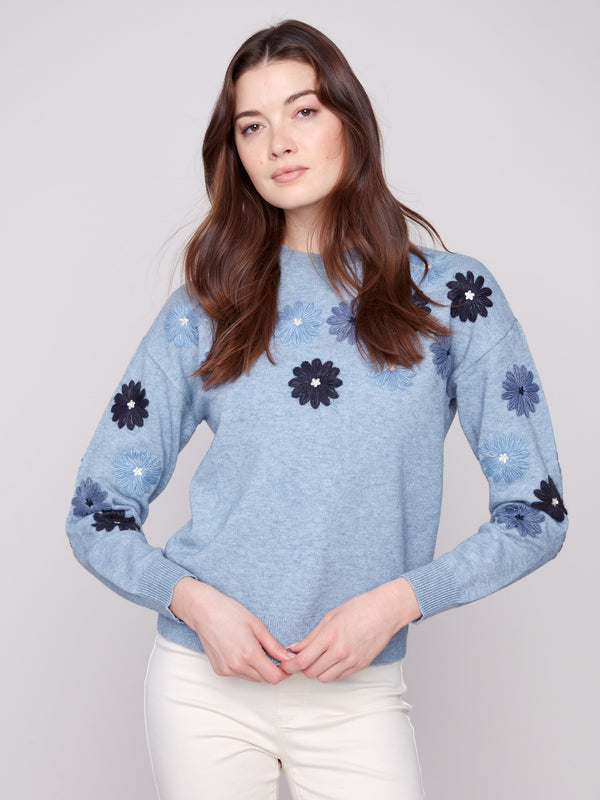 Stylish heather denim sweater adorned with floral embroidery, designed with drop shoulders for added flair by Charlie B.