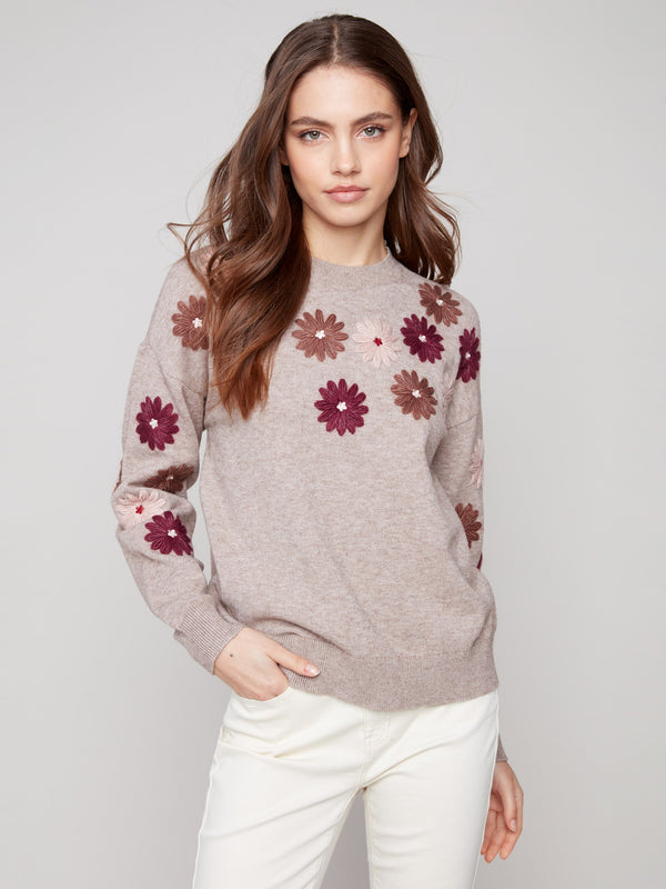Heather taupe sweater adorned with floral embroidery, showcasing a relaxed fit and ribbed cuffs by Charlie B.