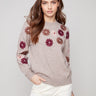 Heather taupe sweater adorned with floral embroidery, showcasing a relaxed fit and ribbed cuffs by Charlie B.