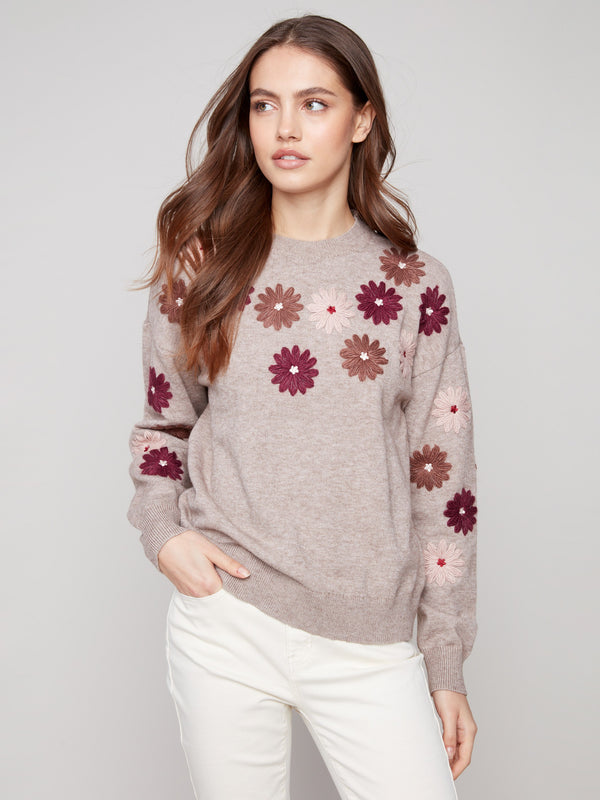 Sweater in heather taupe with floral patterns, highlighting the drop shoulders design for added comfort by Charlie B.