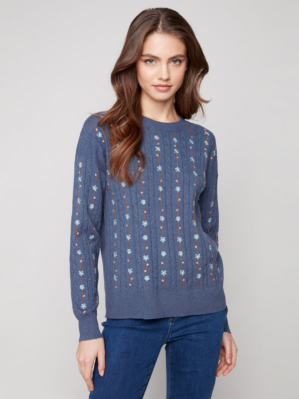 Knit sweater in tulip color adorned with cable plush knit and delicate floral embroidery, complete with a crew neck by Charlie B.