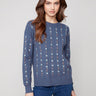 Knit sweater in tulip color adorned with cable plush knit and delicate floral embroidery, complete with a crew neck by Charlie B.