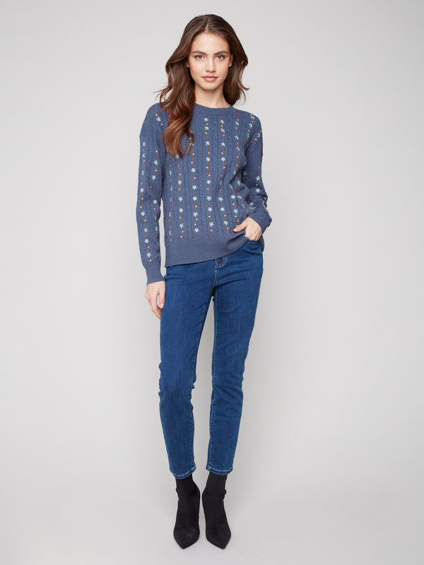 Charming tulip sweater featuring ribbed cuffs and embroidered florals, designed with a cozy crew neck for elegance by Charlie B.