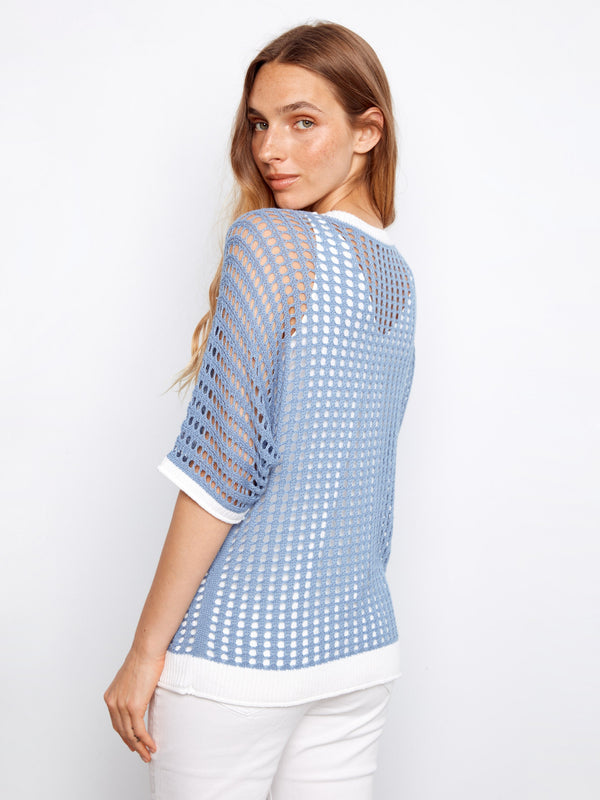 Elegant blue knit with a relaxed fit and detailed floral design, offering both comfort and style. Styled by Charlie B.