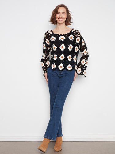 Experience the beauty of a handcrafted crochet design with this exquisite sweater, offering timeless elegance by Charlie B.