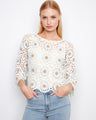 Floral crochet sweater with delicate scalloped hem and intricate detailing, perfect for adding elegance to any outfit by Charlie B.