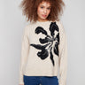 Beige sweater featuring a crew neck and bold abstract flower jacquard, perfect for cozy elegance by Charlie B.